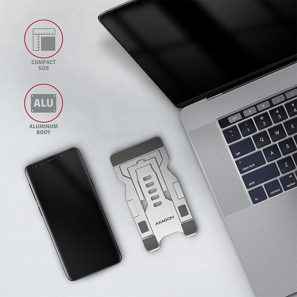 Složený stojan AXAGON STND-M vedle telefonu a notebooku – kompaktní hliníkové tělo