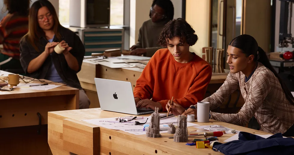 Studenti pracují s MacBookem Pro v dílně